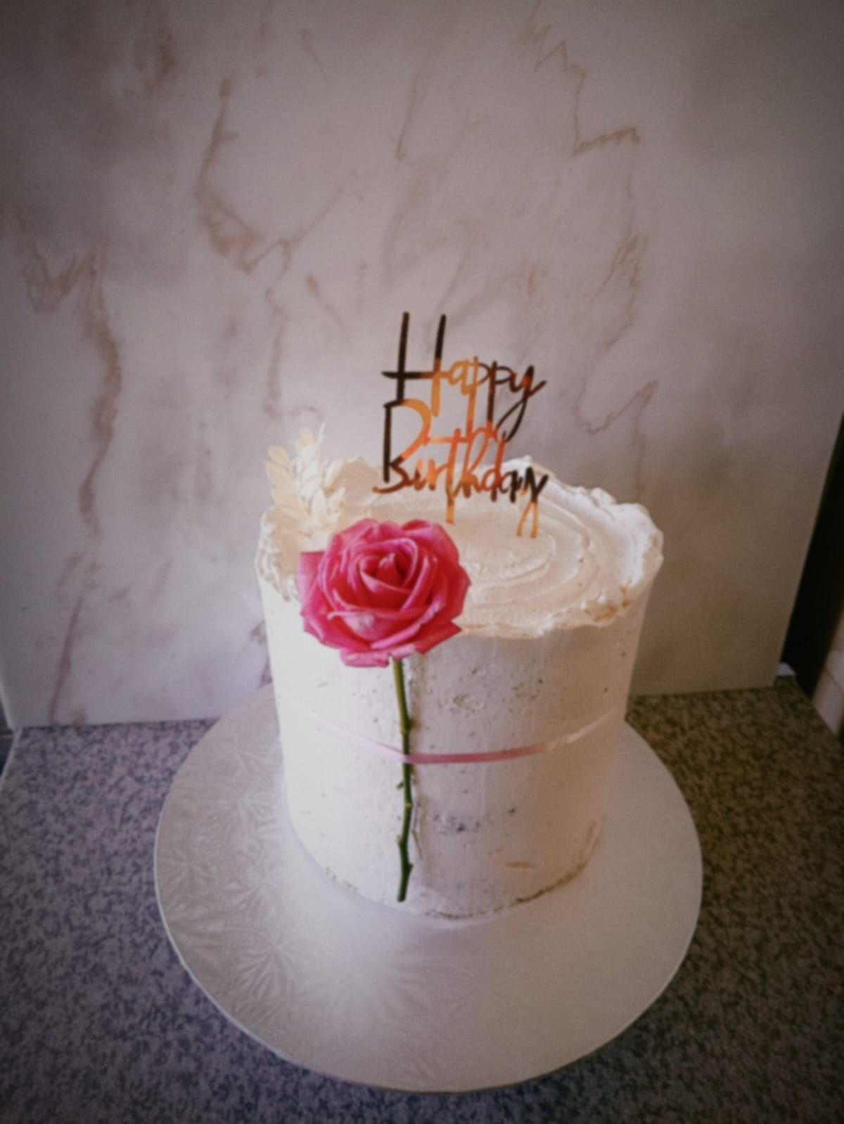 Naked birthday cake with a single pink rose and 24th birthday topper