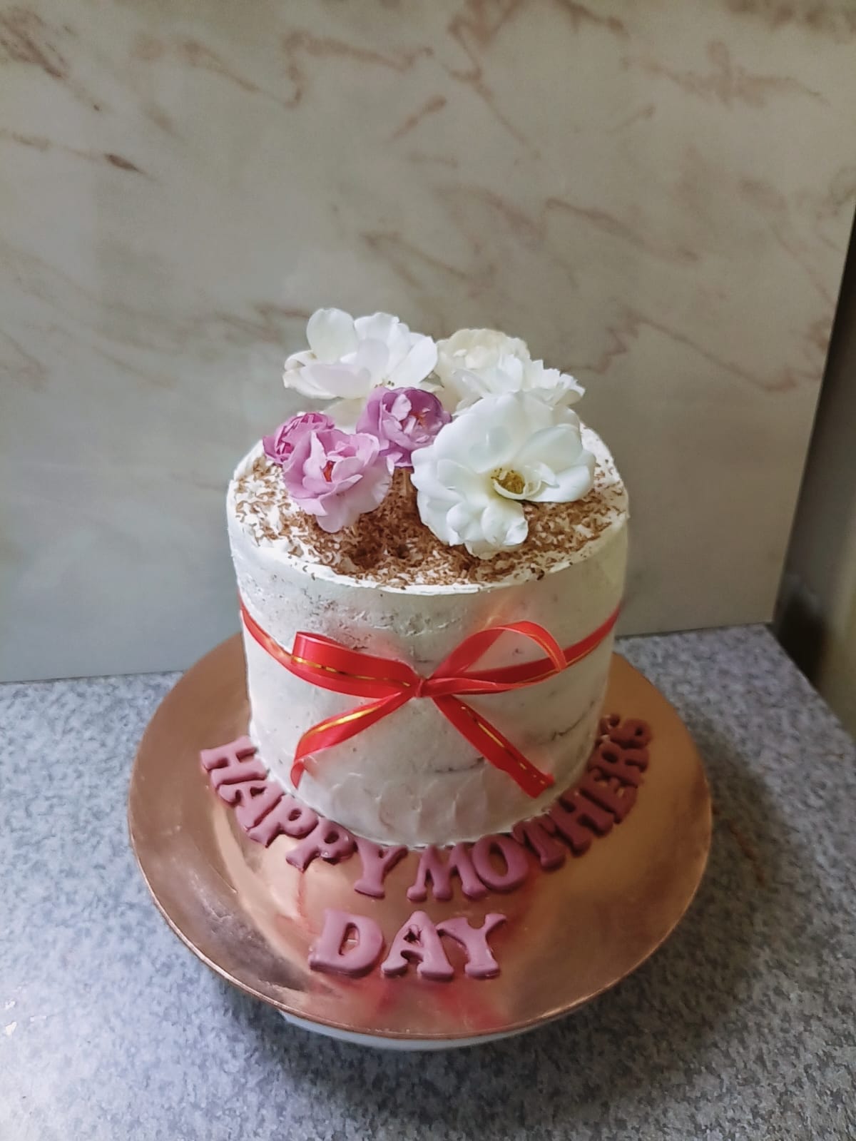 Mother's Day floral cake with ribbon and pink lettering